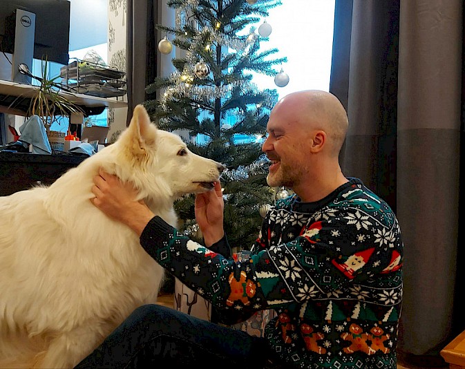Genevia CEO Antti Ylipää with office dog Luna during the holiday season.